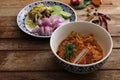 Local northern Thai food Egg noodle curry with fried pork on wood background Royalty Free Stock Photo