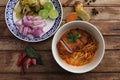 Local northern Thai food Egg noodle curry with fried pork on wood background Royalty Free Stock Photo