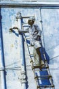 Local painter paints the old wall in the typical blue color