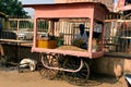 Local peanut seller reading the paper