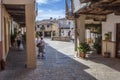 Local people chatting at Three jets fountain on the square, Guadalupe old Town, Spain