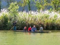 Local people riding in a boat on Nam Song River near Vang Vieng, Vientiane Province, Laos. Royalty Free Stock Photo