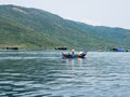 Local people riding a boat near Whale Island, Vietnam Royalty Free Stock Photo