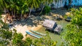 Local people tap new location, Bamboo Hut and Boats on Beach in low Tide, Kabui Bay near Waigeo. West Papuan, Raja Ampat Royalty Free Stock Photo