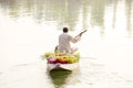 Local people use Shikara, a small boat for transportation in the Dal lake of Srinagar, Jammu and Kashmir state, India. A man carri Royalty Free Stock Photo