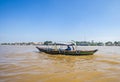 Local People using traditional boat for transportation in the middle of Musi River, Palembang, Indonesia. Royalty Free Stock Photo