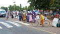 Local people wait at the bus stop and chat after coming from the daily market in the town center of Moshi