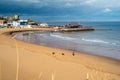 Local people walk their dogs Viking Bay during an autumnal day of moody clouds and sunshine. There is