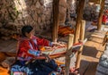 Local Peruvian village woman making colorful handmade textiles at the Awanacancha Textile site in Peru outside of Cusco.