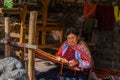 Local Peruvian village woman making colorful handmade textiles at the Awanacancha Textile site in Peru outside of Cusco.