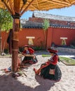 Local Peruvian village women making colorful handmade textiles at textile site in Chinchero, Peru.