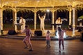 Local pop rock music band performs in gazebo of city public park, energetic outdoor performance