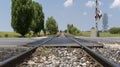 Local railway with the asphalt road crossing in a countryside, Afyonkarahisar, Turkey