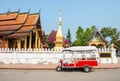 The local red Tuk Tuk parking in front of Wat Sensoukaram one of the most popular temple in Luang Prabang the UNESCO world heritag Royalty Free Stock Photo