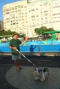 Local resident greeting athletes competing at Rio 2016 Olympic Cycling Road at Copacabana Beach