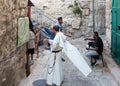 A local resident shows a monk on a map how to get there in the Old City in Jerusalem, Israel Royalty Free Stock Photo