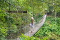 Local Resident Walking on the Suspension Bridge in Tangkahan, In