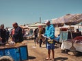 Local salesman holding a long fish, Morocco