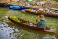 Local seller with bananas at a floating market in Thailand