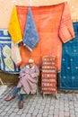 Local seller offers textile in souks in Marrakesh, Morocco