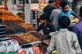 A local selling dried fruit at the street market in Delhi, India.