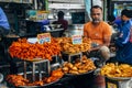 A local selling fried meat at the street market in Delhi, India.