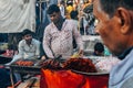 A local selling kabobs at the street market in Delhi, India.