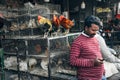 A local selling live chickens at the street market in Delhi, India.
