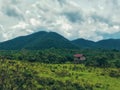 Local stilt hut with cloudy sky in tropical landscape Royalty Free Stock Photo