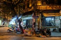 Local street food vendor at a corner in Hanoi's Old Quarter at night.