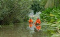 Local Thai monks with alms. A man sailing wooden boat in canal or river for receiving food, Traditional Thai Buddhism lifestyle.