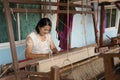 Local Thai weaver crafting traditional silk on a loom