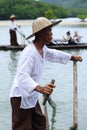Local Tourism Boat white shirt weaving hat in rain, in mangrove