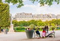 Local and Tourist enjoy sunny days in famous Tuileries garden. Jardin des Tuileries is a public garden located between Louvre Royalty Free Stock Photo