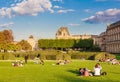 Local and Tourist enjoy sunny days in famous Tuileries garden. Jardin des Tuileries is a public garden located between Louvre Royalty Free Stock Photo