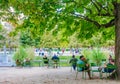 Local and Tourist enjoy sunny days in famous Tuileries garden. Jardin des Tuileries is a public garden located between Louvre Royalty Free Stock Photo