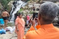 Local tourist taking photos with mobile phone at Ravana falls