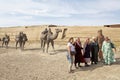 Local tourists among the sculpture of traveler and camels near the gosth town of Otrar, the ancient city along the Silk Road in