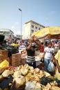 A local trader selling coconuts at a street market in Accra, Ghana