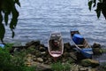 Boats of local fishers were harbored in the rocky beach in Toba Lake, North Sumatra, Indonesia