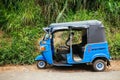 A local tuktuk parked by the side of the road in rural Nuwara Eliya, Sri Lanka