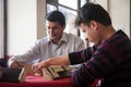 Local turkish men playing very table game Okey, or rummikub, in