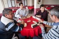 Local turkish men playing very table game Okey, or rummikub, in