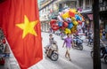 Local vendor carrying a bunch of colourful balloons, Hanoi, Vietnam