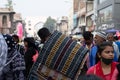 Local vendor carrying carpets on his back on a busy Charminar street Royalty Free Stock Photo