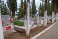 Birgi, Izmir, Turkey - 03.09.2021: Turkish graveyard with trees and marble ornaments and Turkish flag in Birgi village