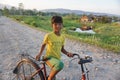 Chitwan Nepal Jun 10 2020  : Local village kid posing for a camera while cycling   from Chitwan  Nepal Royalty Free Stock Photo