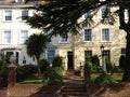 Local vintage historical flat houses by the street with front garden and stair entrance