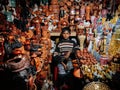 Local vintage pottery shop in Dhaka city market with young seller. Bangladesh