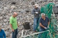 Local volunteer people cleaning the beach after a storm in Ponta do Sol, Madeira